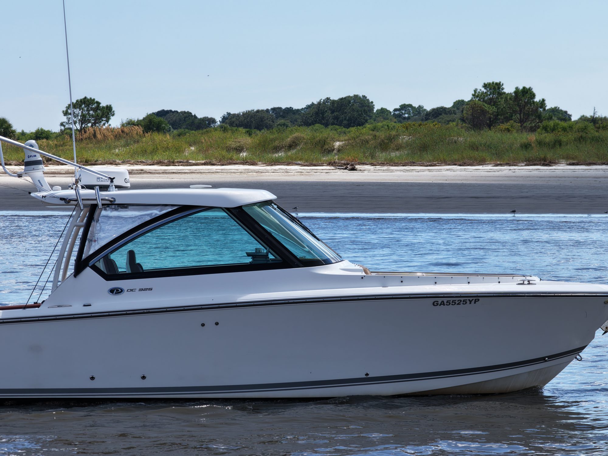 The boat side-on near a barrier island beach